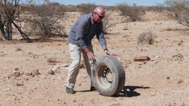 Rolling tire in Namibia desert