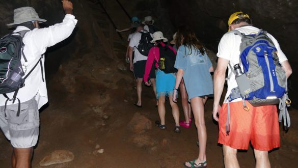 walking through a dark lava tunnel on Floreana Island