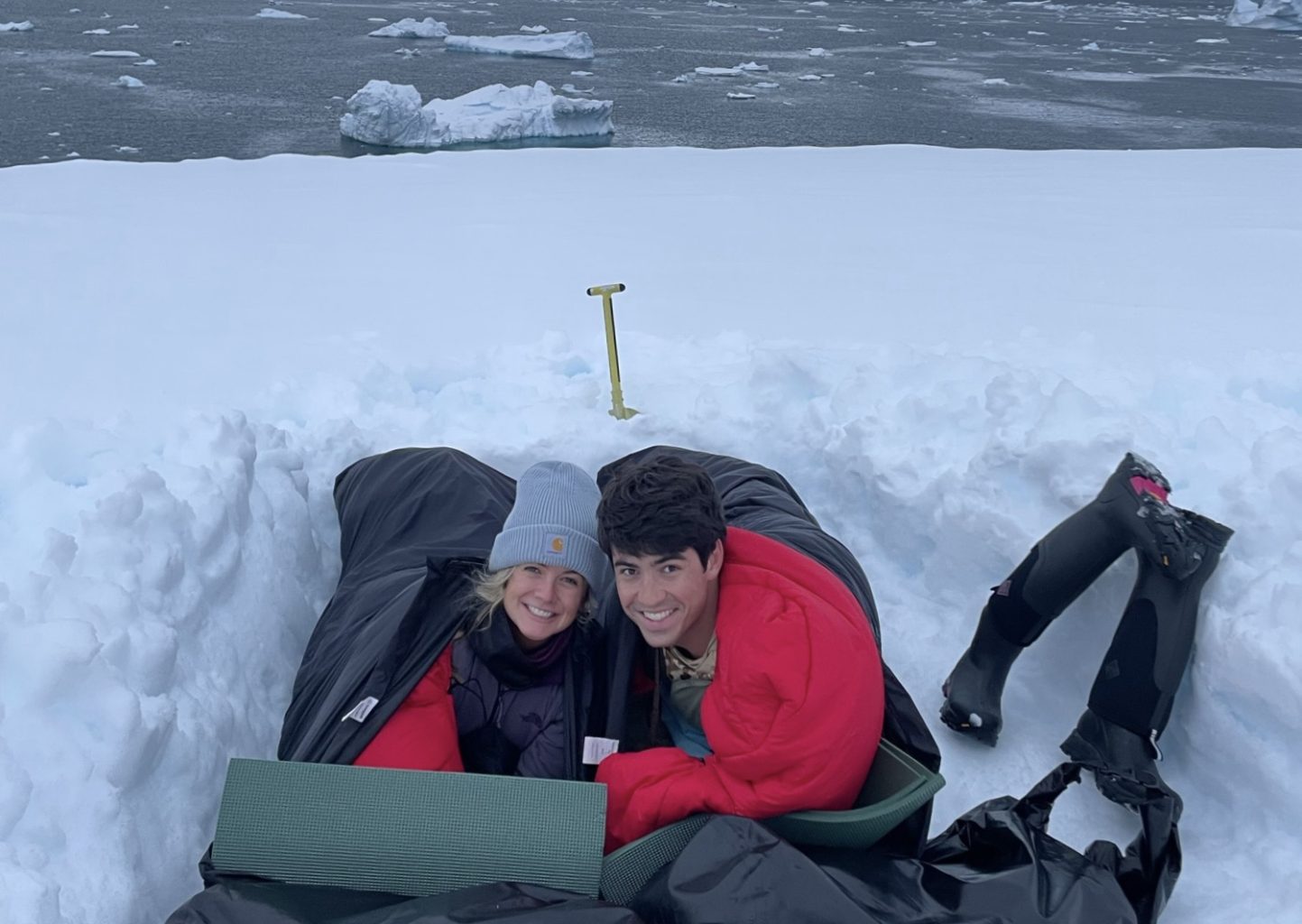 couple in sleeping bag in snow in Antarctica
