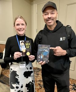 Kellie and author Jerry Craft holding each other's book